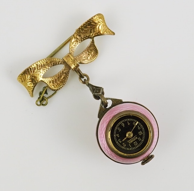 An early to mid 20th century silver and pink guilloche enamel Burger manual wind globe lapel watch, on a later 9ct gold ribbon bow suspension brooch